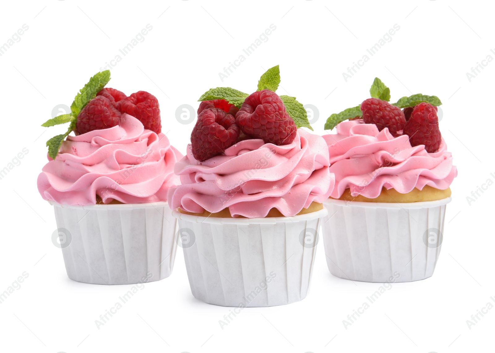 Photo of Tasty cupcakes with raspberries and mint isolated on white