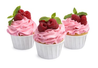 Photo of Tasty cupcakes with raspberries and mint isolated on white