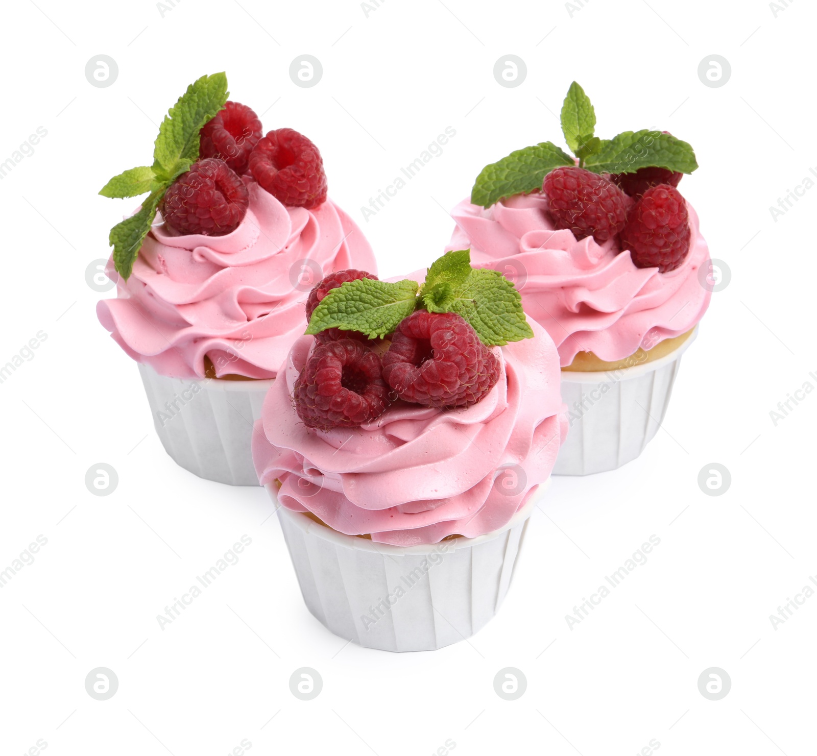 Photo of Tasty cupcakes with raspberries and mint isolated on white