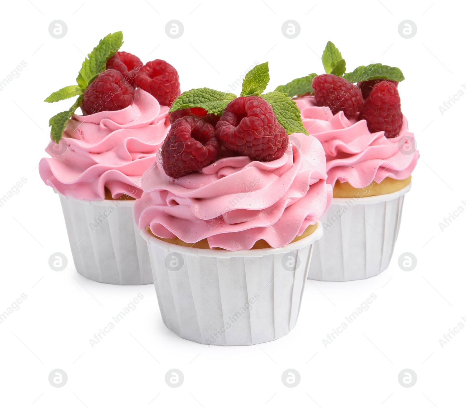 Photo of Tasty cupcakes with raspberries and mint isolated on white