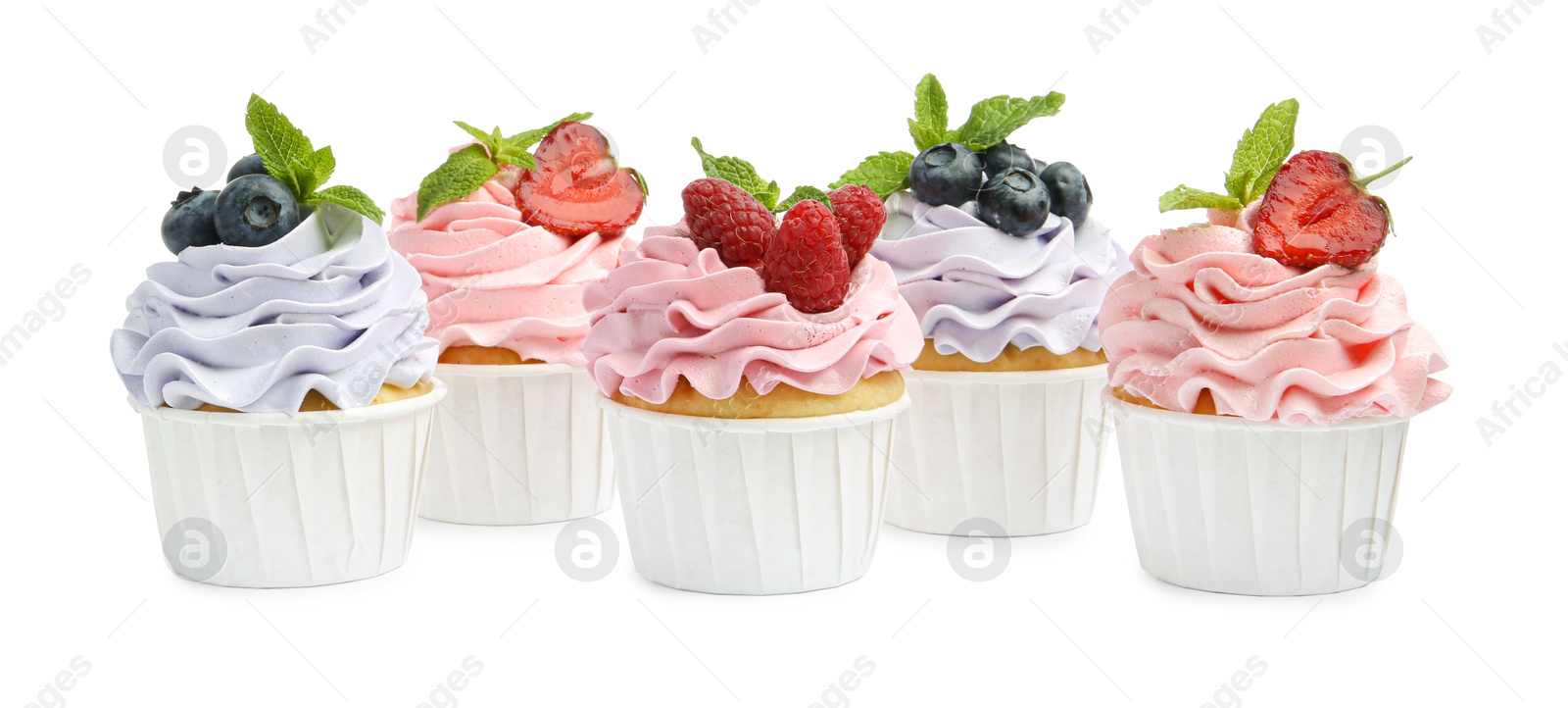 Photo of Tasty cupcakes with different berries isolated on white