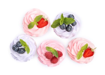 Photo of Tasty cupcakes with different berries isolated on white, top view