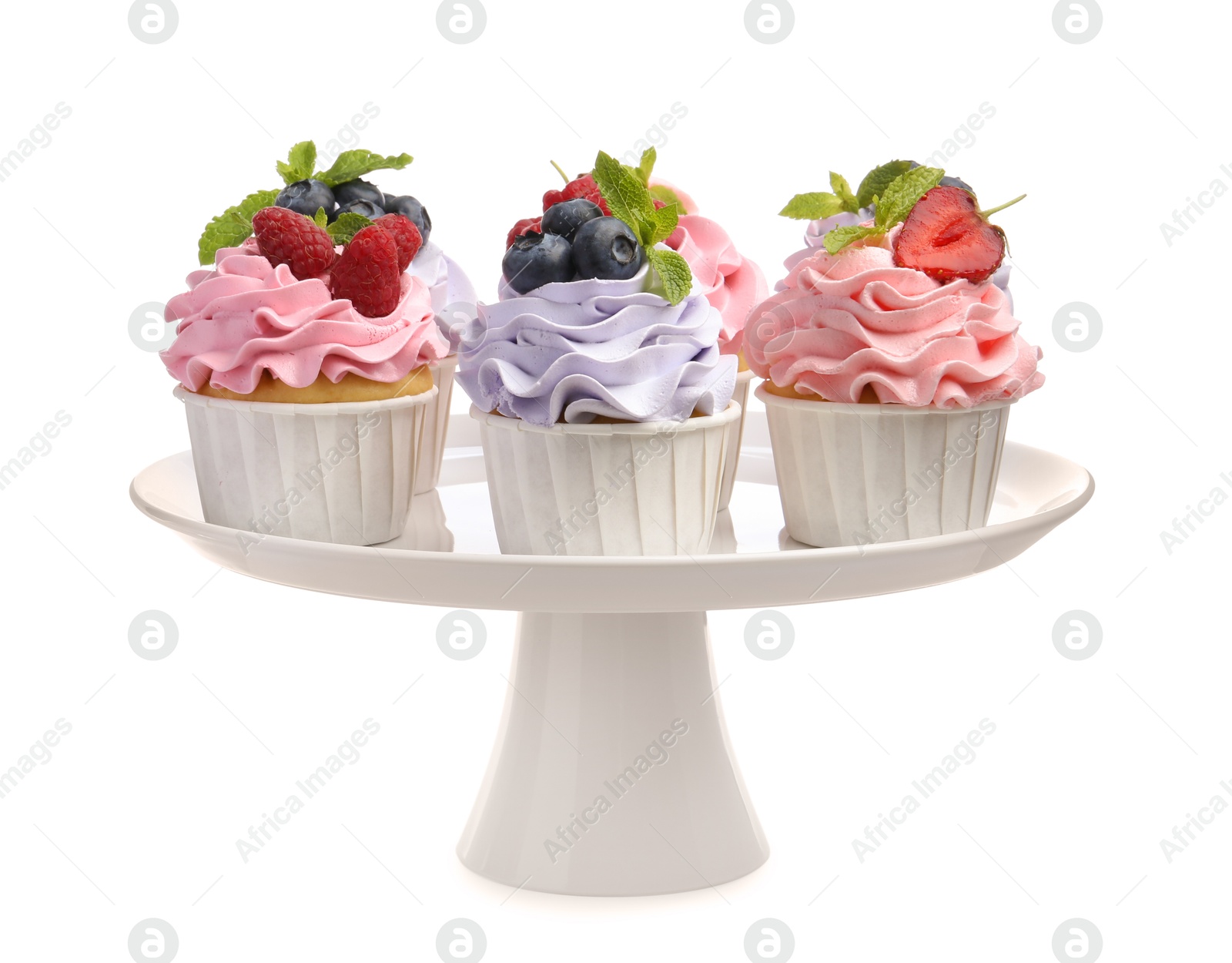 Photo of Tasty cupcakes with different berries isolated on white