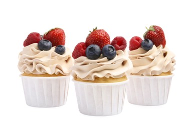 Photo of Tasty cupcakes with different berries isolated on white