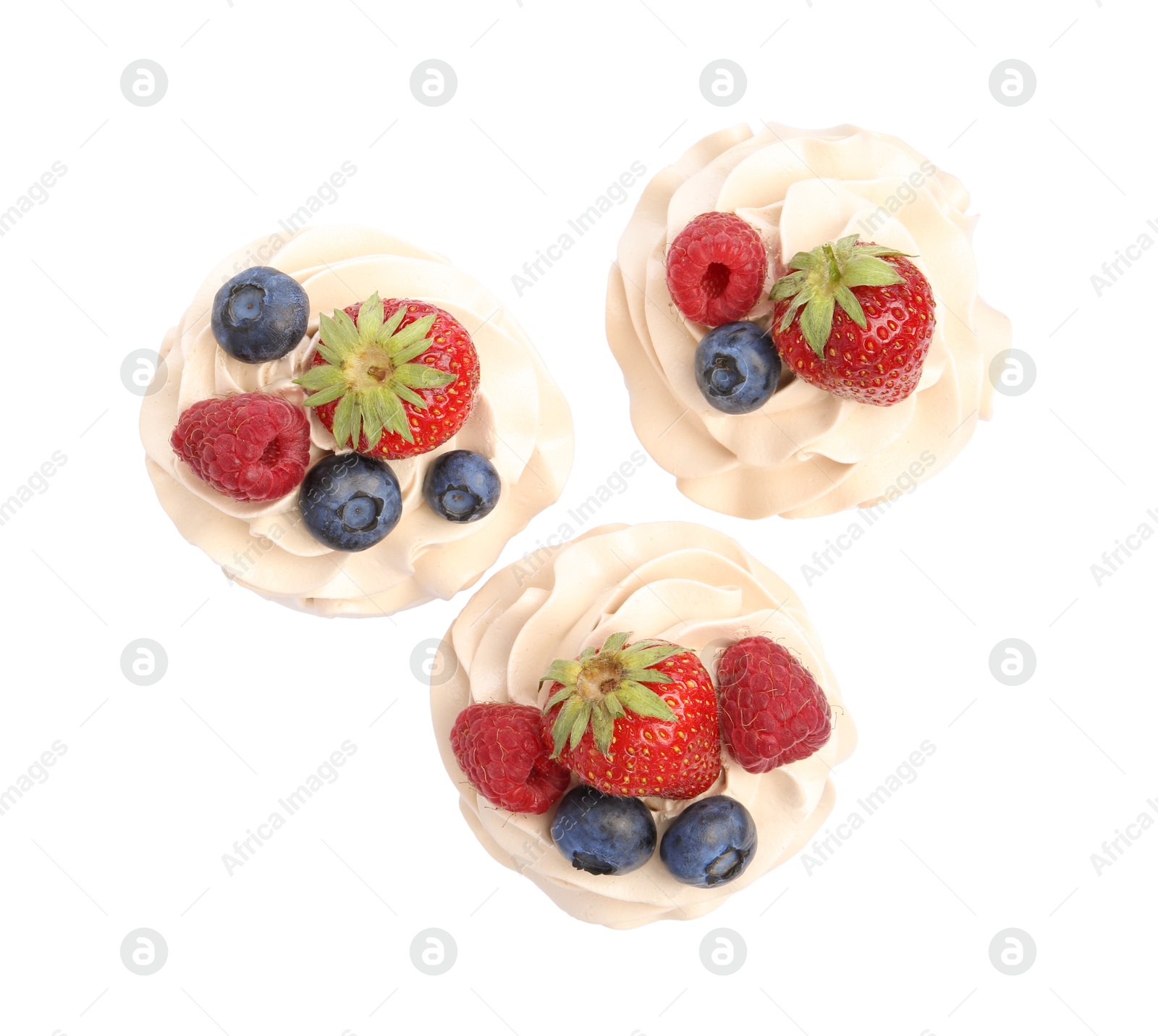 Photo of Tasty cupcakes with different berries isolated on white, top view