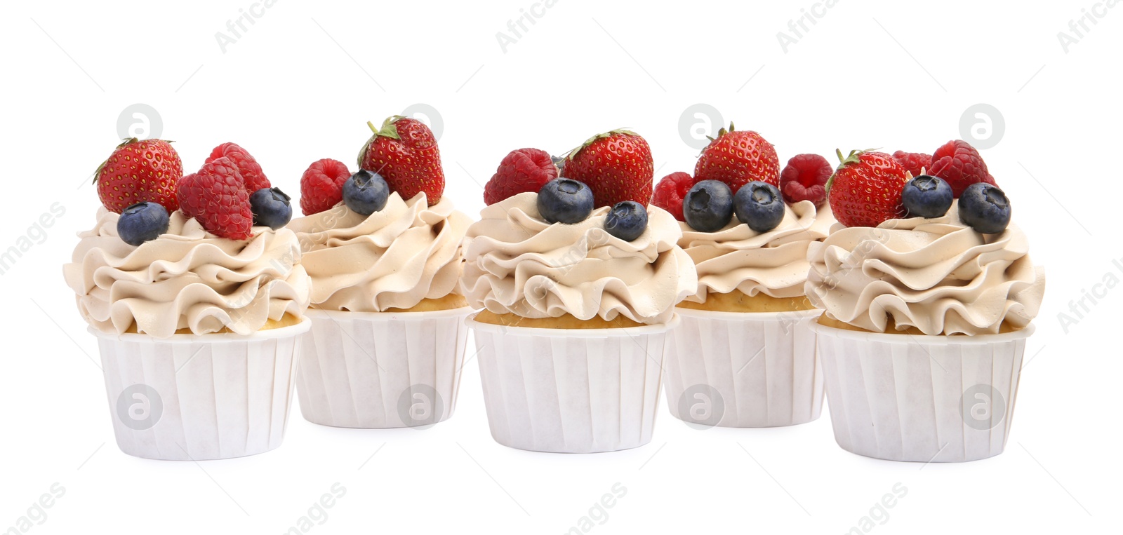 Photo of Tasty cupcakes with different berries isolated on white