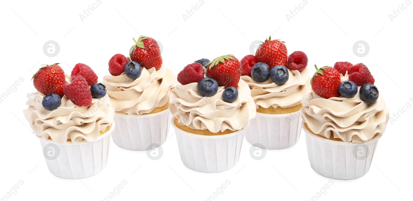 Photo of Tasty cupcakes with different berries isolated on white