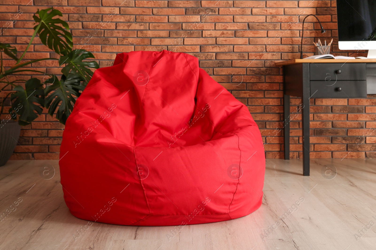 Photo of Red bean bag chair on floor in room