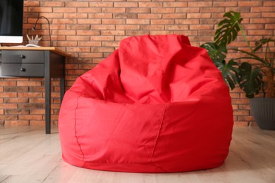 Red bean bag chair on floor in room