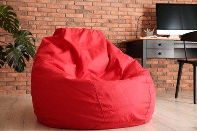 Red bean bag chair on floor in room