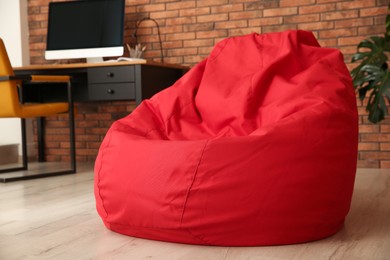 Red bean bag chair on floor in room