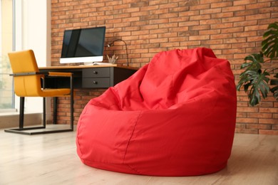 Red bean bag chair on floor in room