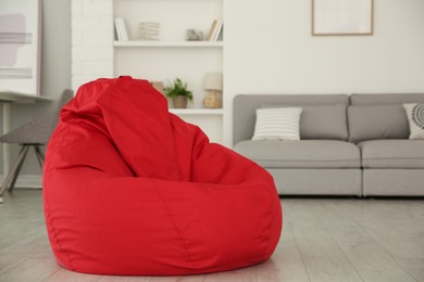 Red bean bag chair on floor in room