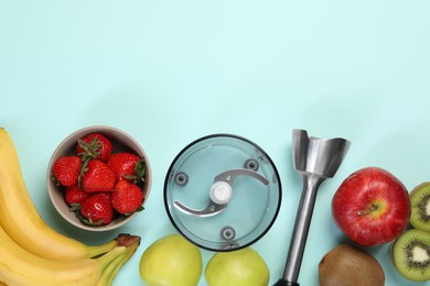 Photo of Hand blender kit and fresh fruits on light blue background, flat lay. Space for text