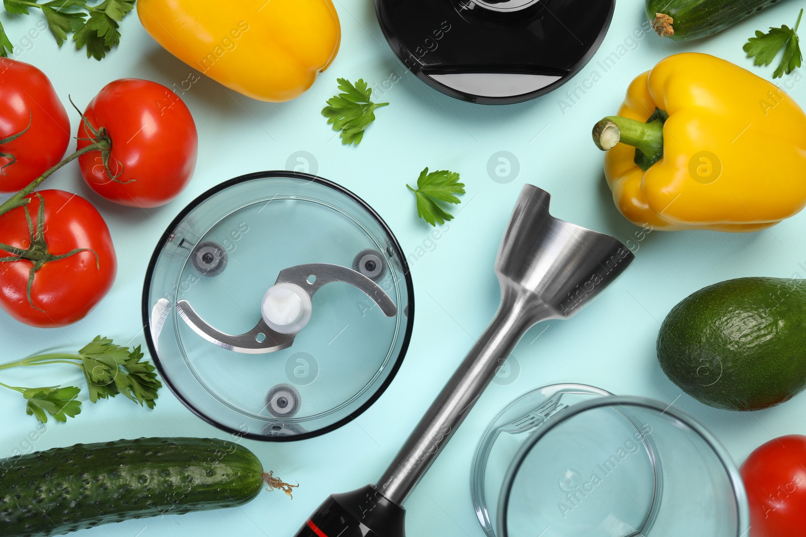 Photo of Hand blender kit and fresh products on light blue background, flat lay