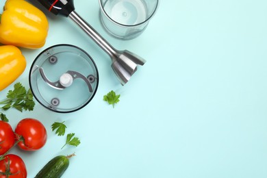 Photo of Hand blender kit and fresh products on light blue background, flat lay. Space for text