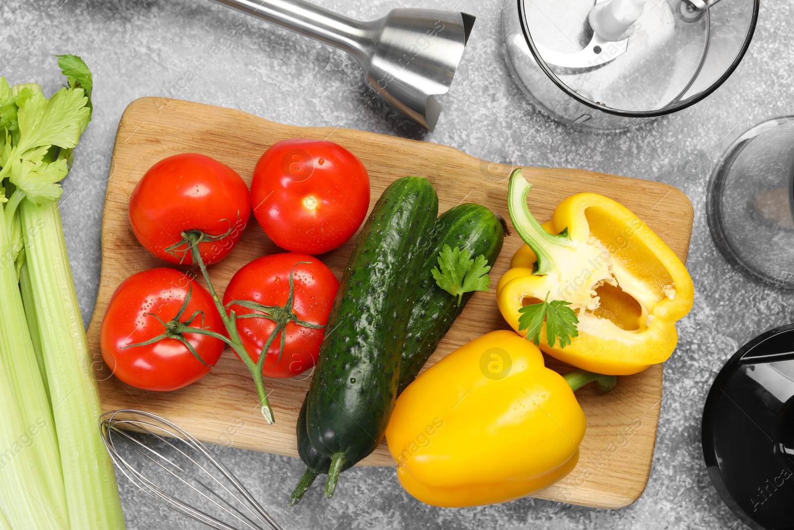 Photo of Hand blender kit and fresh products on grey table, top view