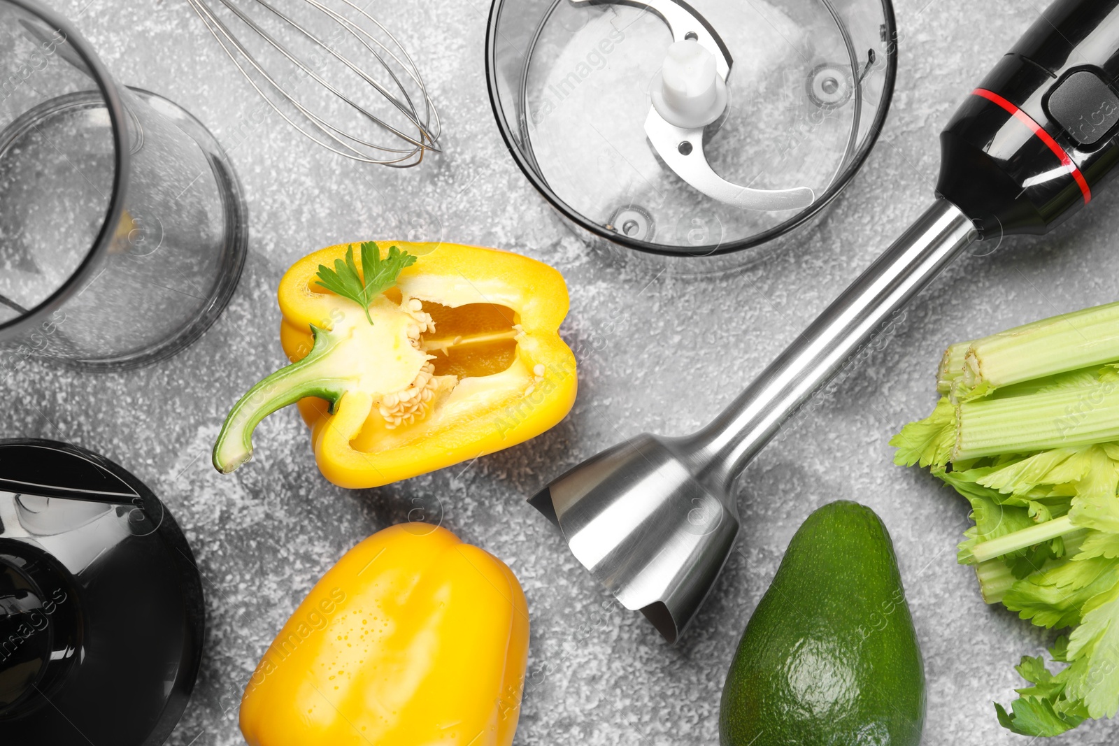 Photo of Hand blender kit and fresh products on grey table, flat lay