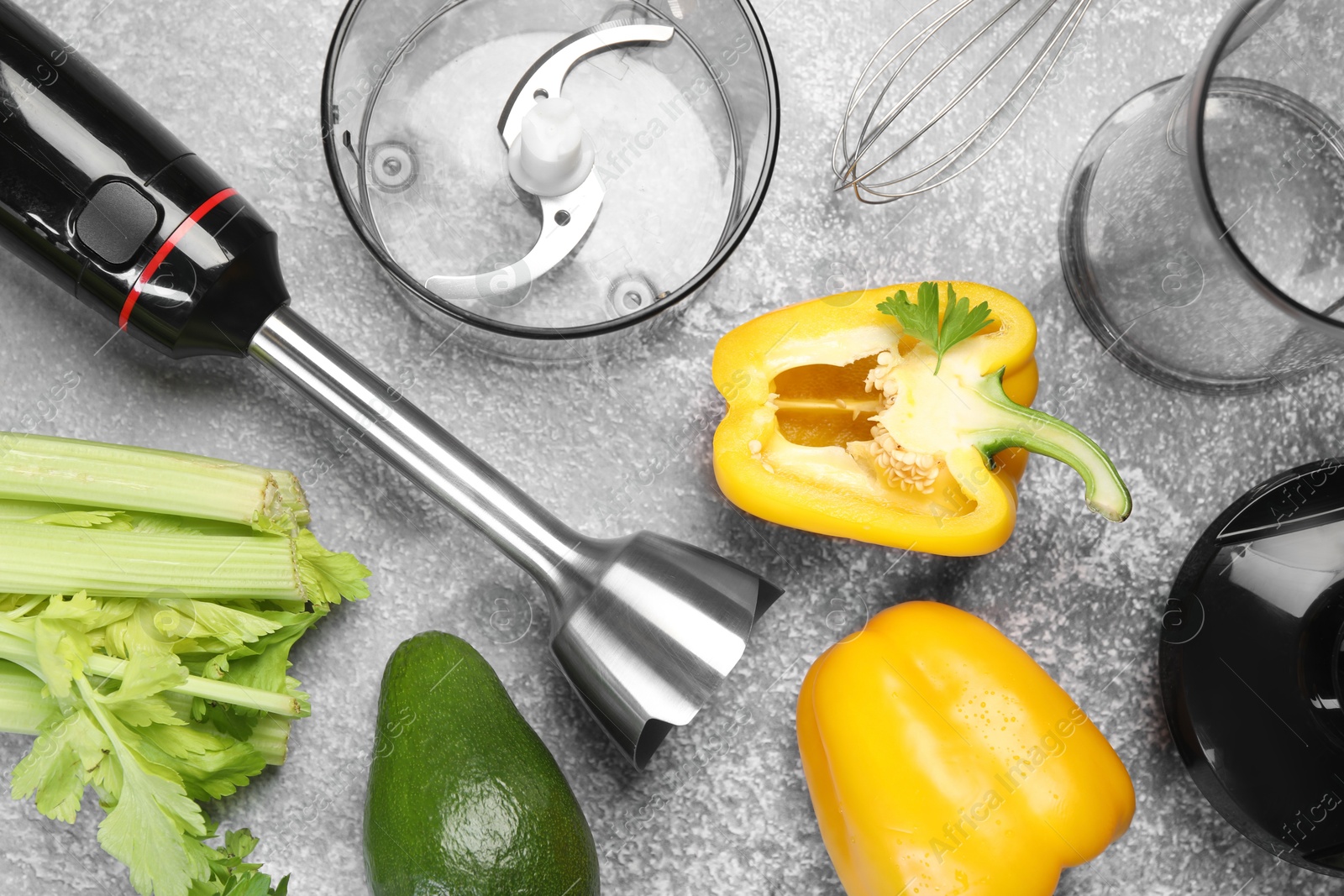 Photo of Hand blender kit and fresh products on grey table, flat lay