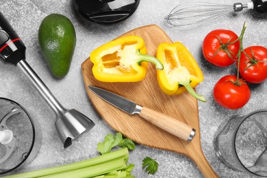 Photo of Hand blender kit, knife and fresh products on grey table, flat lay