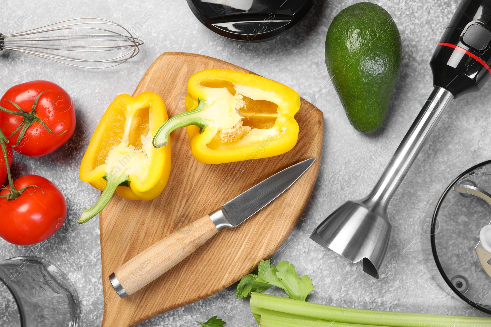 Photo of Hand blender kit, knife and fresh products on grey table, flat lay