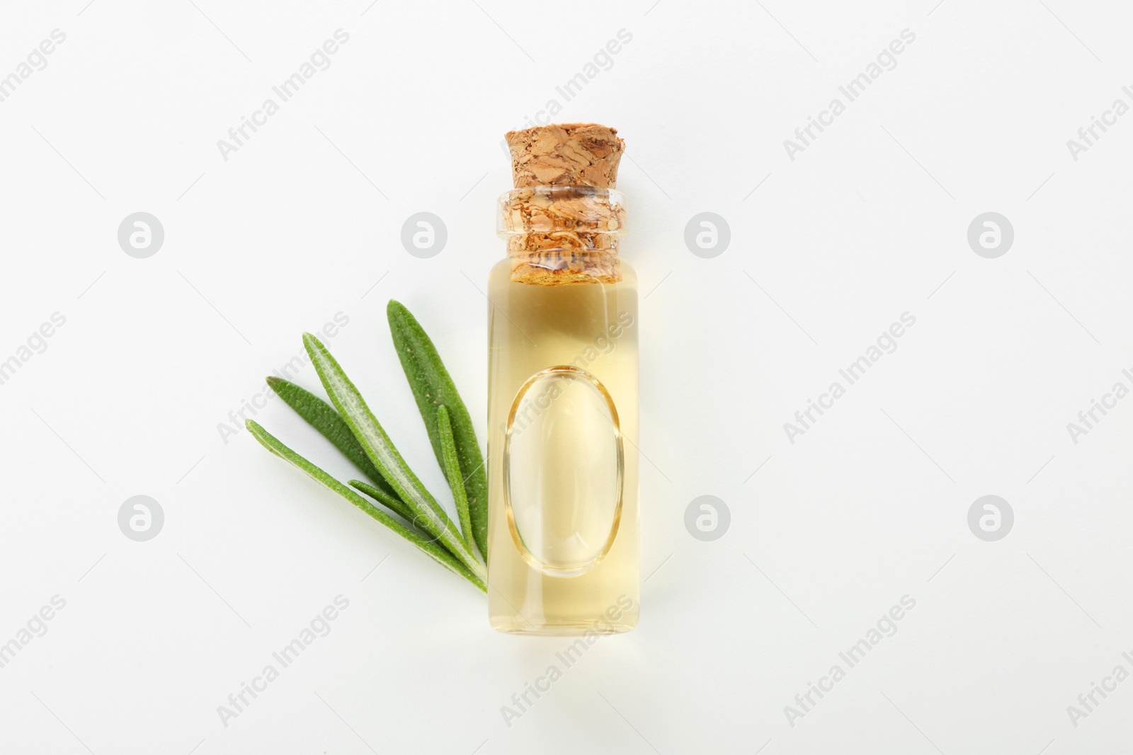 Photo of Bottle of essential oil and fresh rosemary on white background, flat lay