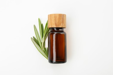 Photo of Bottle of essential oil and fresh rosemary on white background, flat lay