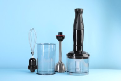 Photo of Hand blender kit on light blue background