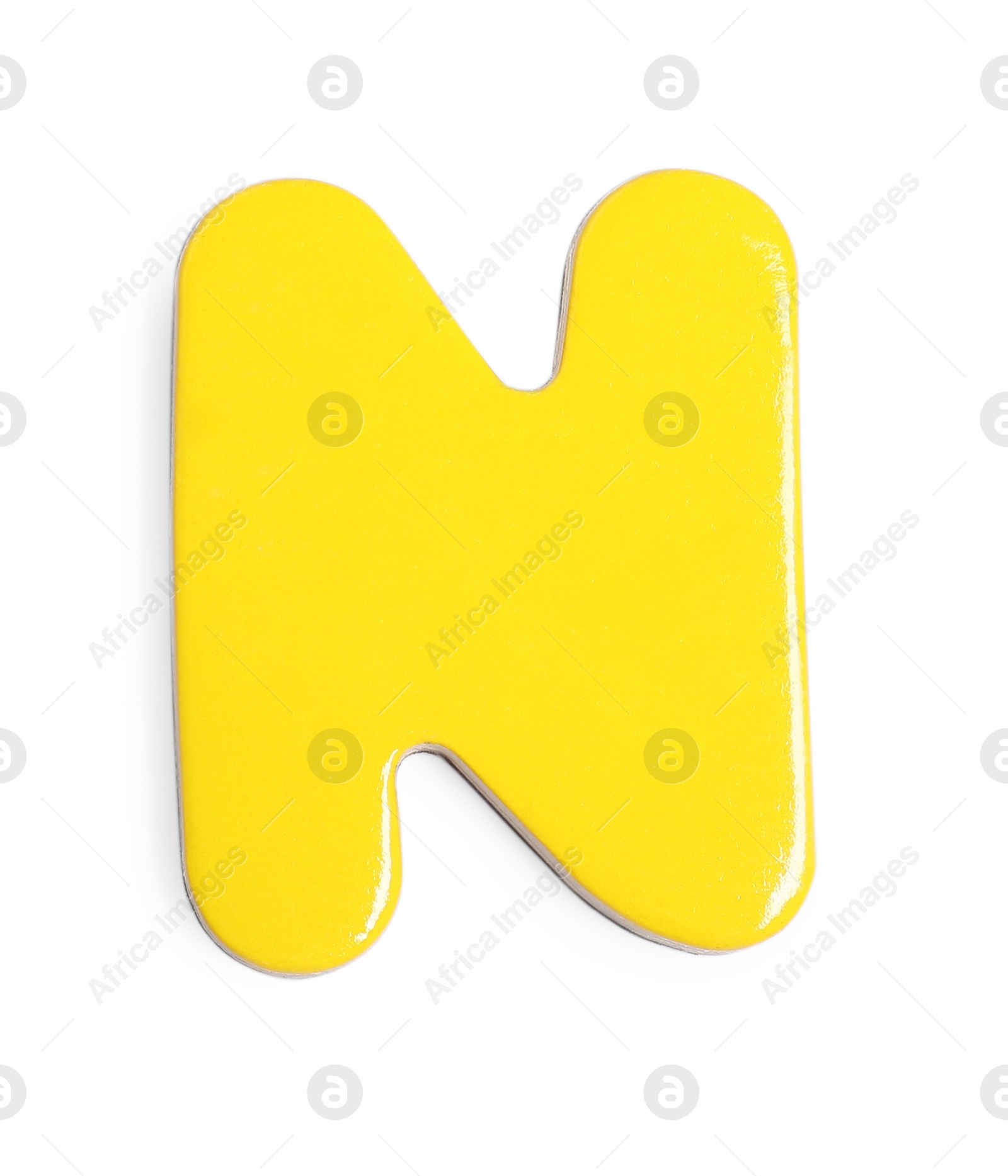 Photo of Yellow magnetic letter N isolated on white, top view. Alphabet