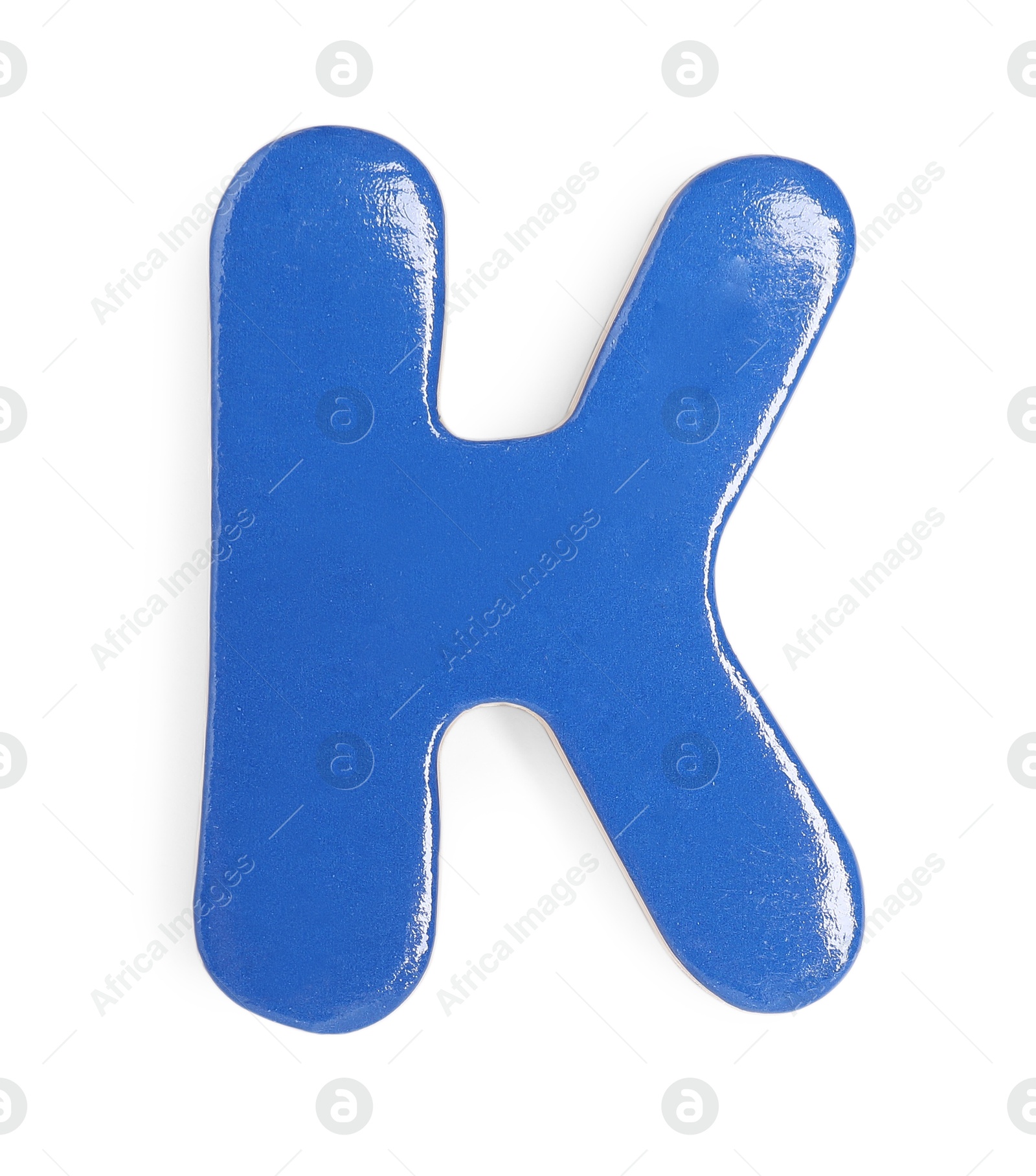 Photo of Blue magnetic letter K isolated on white, top view. Alphabet