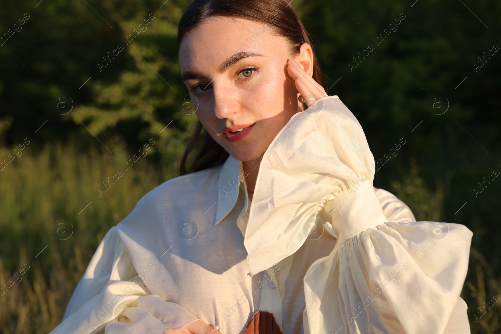 Photo of Beautiful woman in stylish corset posing outdoors