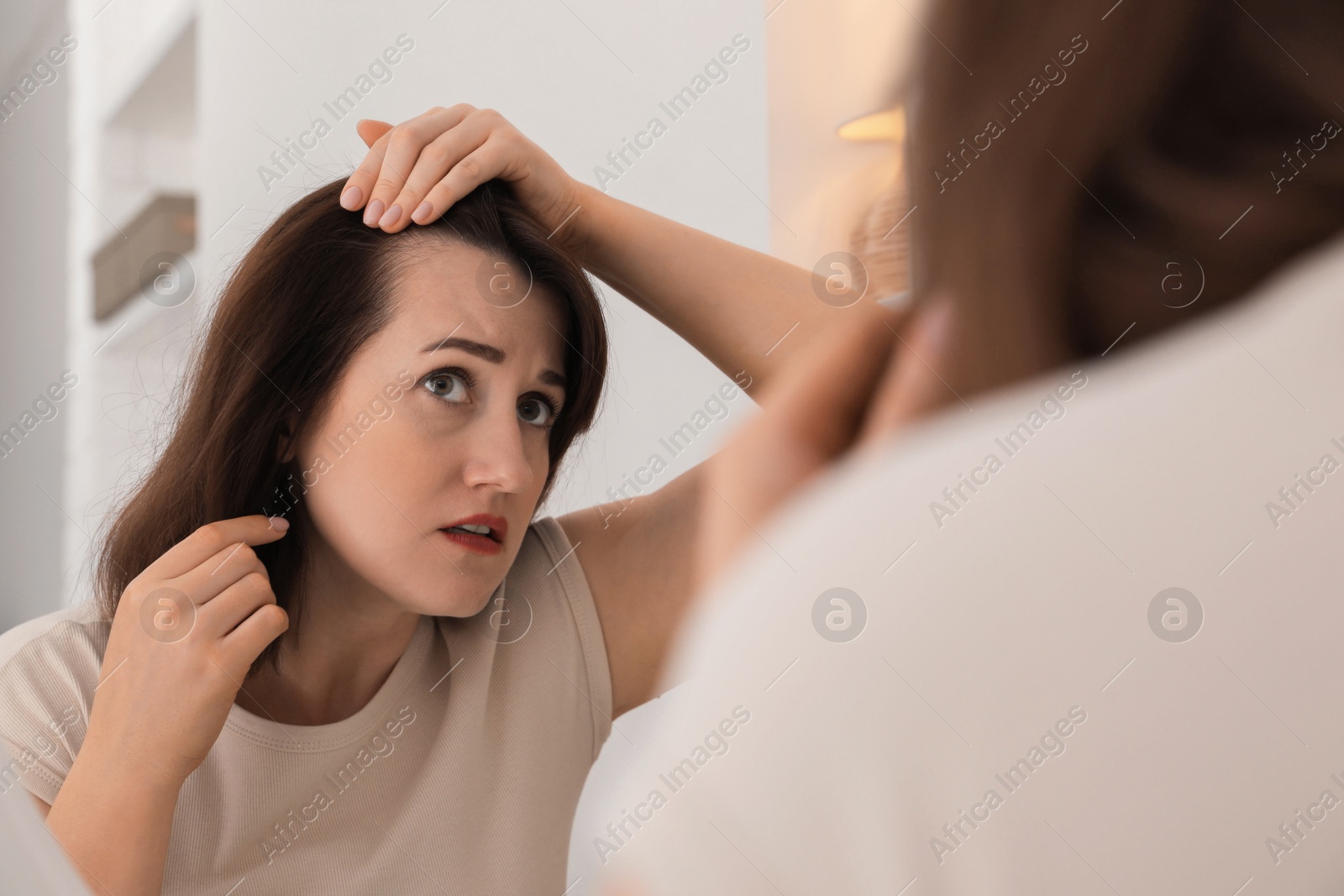 Photo of Woman with hair loss problem at home