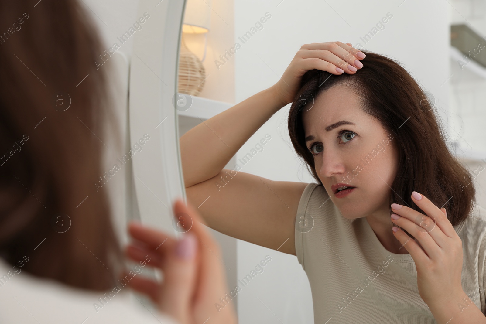 Photo of Woman with hair loss problem at home