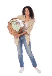 Photo of Happy woman with basket full of laundry on white background