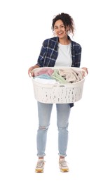 Happy woman with basket full of laundry on white background