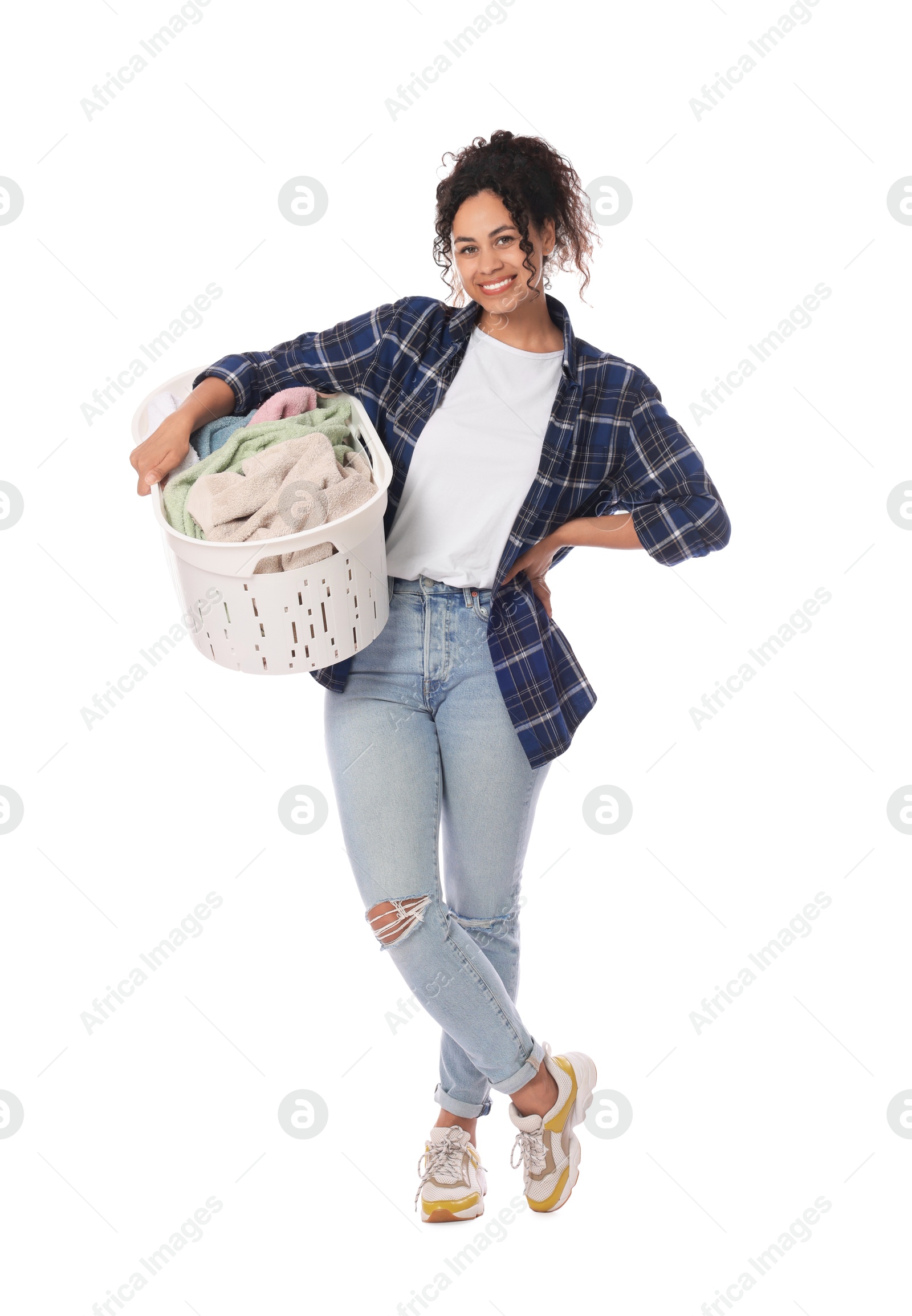 Photo of Happy woman with basket full of laundry on white background