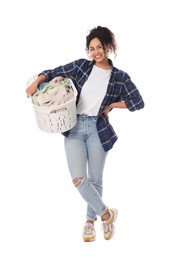 Happy woman with basket full of laundry on white background