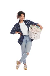 Happy woman with basket full of laundry on white background