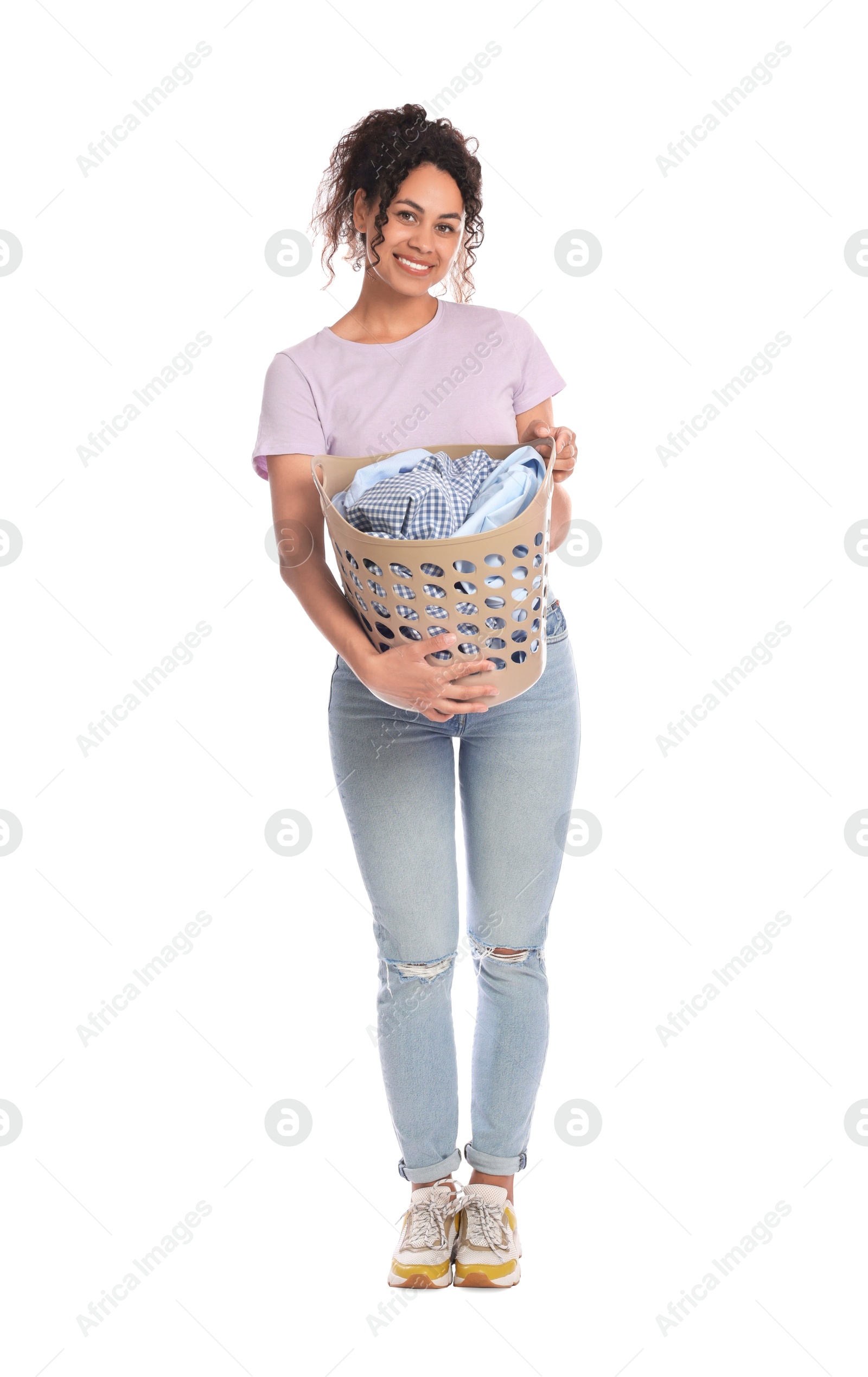 Photo of Happy woman with basket full of laundry on white background