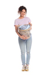 Photo of Happy woman with basket full of laundry on white background