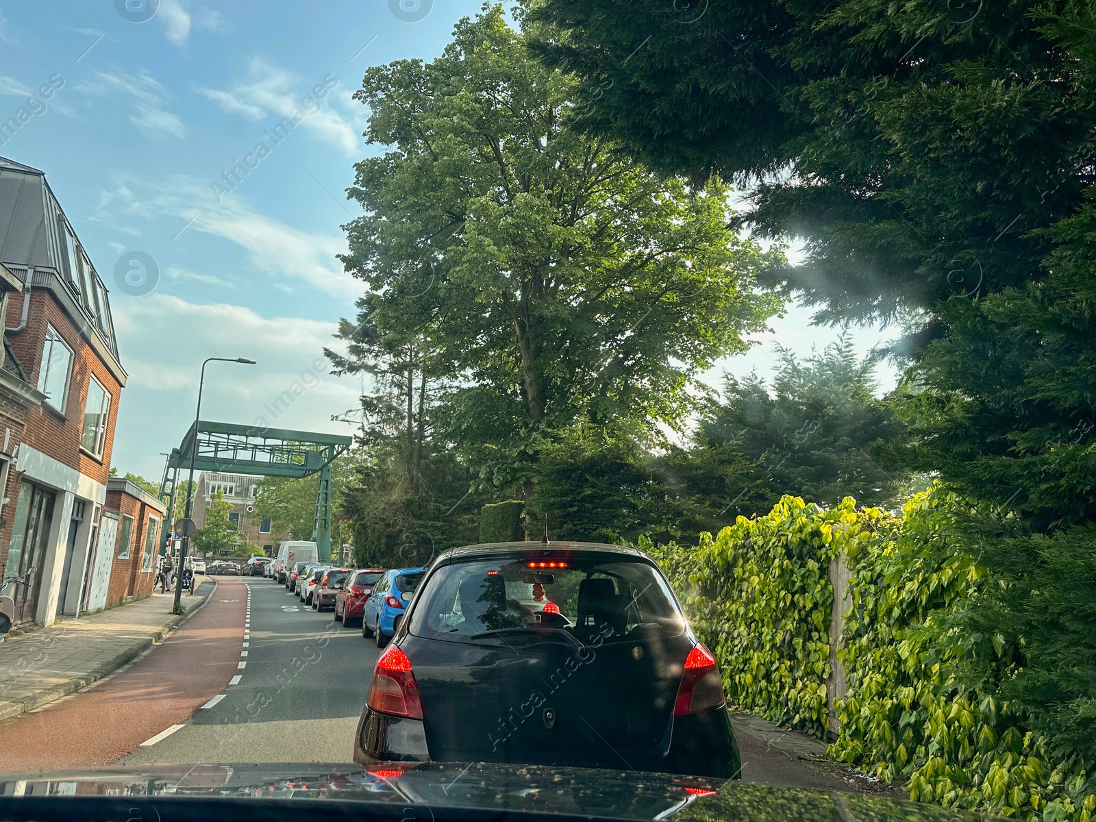 Photo of Cars in traffic jam on city street, view from driver's seat