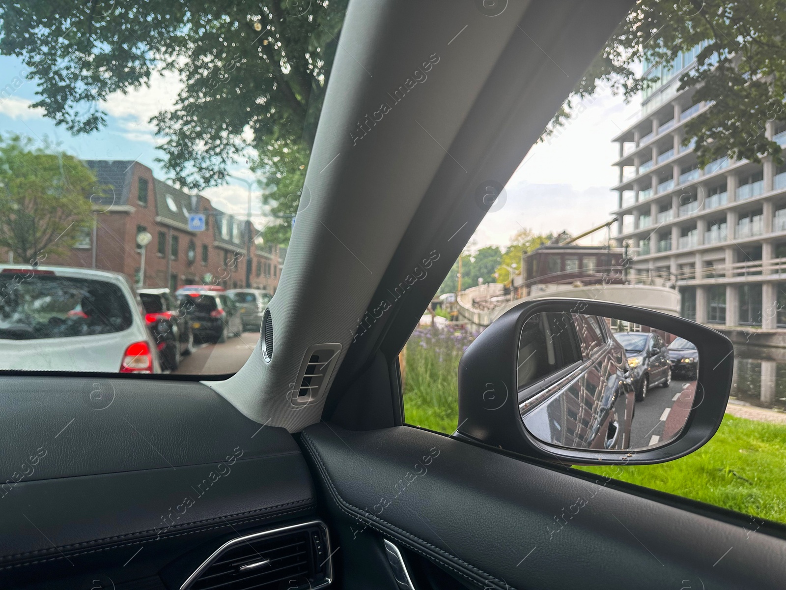 Photo of Cars in traffic jam on city street, view from driver's seat