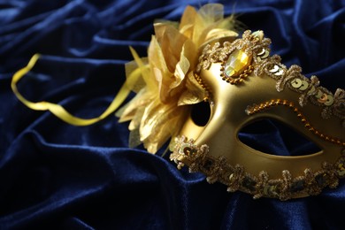 One beautiful carnival mask on blue fabric