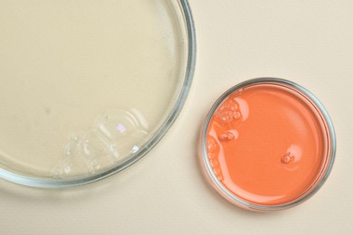 Photo of Petri dishes with samples on beige background, top view