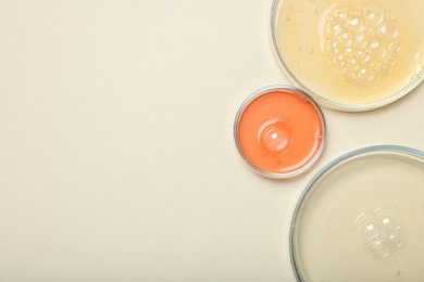 Photo of Petri dishes with samples on beige background, top view. Space for text