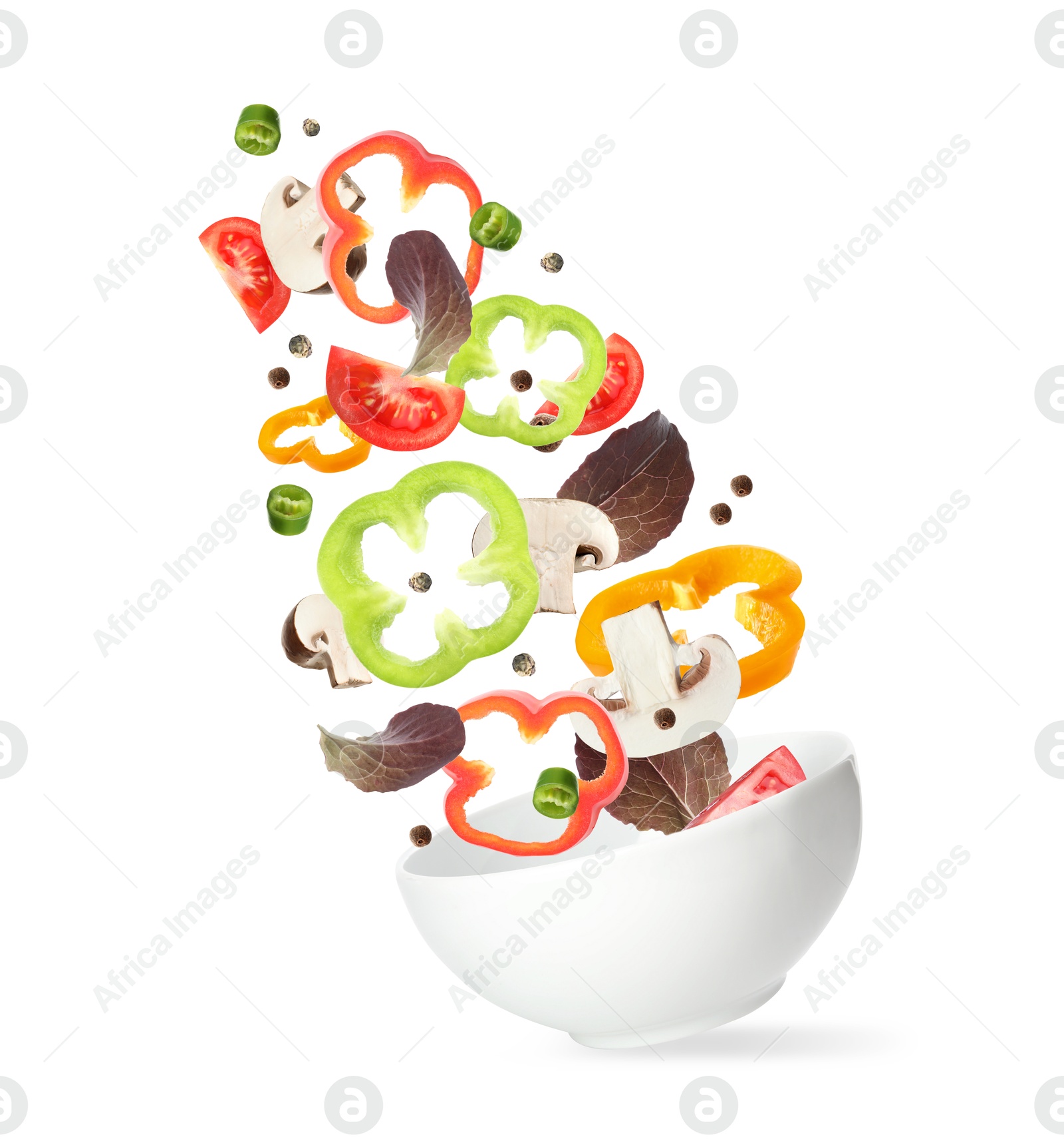 Image of Bowl with fresh vegetables in air on white background. Making fresh salad