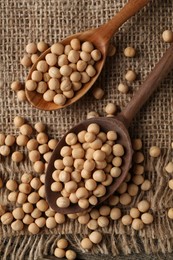 Spoons with dried peas on table, top view