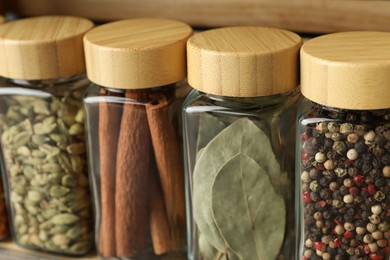 Photo of Many different spices in glass jars, closeup