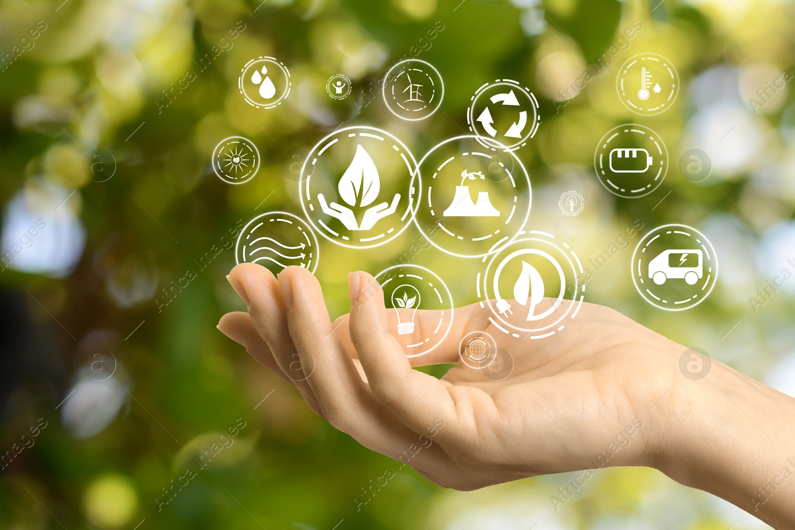 Image of Environmental protection. Woman holding many different icons in nature, closeup