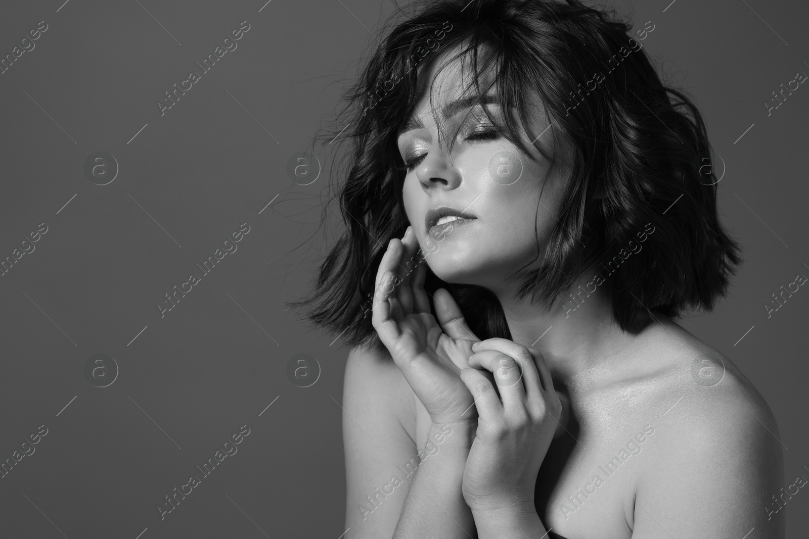 Image of Attractive woman on grey background. Fashionable black and white portrait